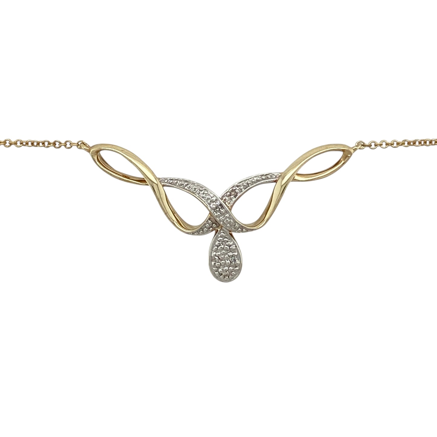 Bring graceful movement and subtle sparkle to your jewellery collection with this pre-owned 9ct yellow and white gold diamond set swirl necklace, a refined design with timeless elegance.

Design: The necklace features a flowing swirl motif accented with diamonds, creating a soft and elegant focal point with gentle sparkle.
Material: Made from a combination of 9-carat yellow and white gold, the contrasting tones add depth and highlight the fluid design.
