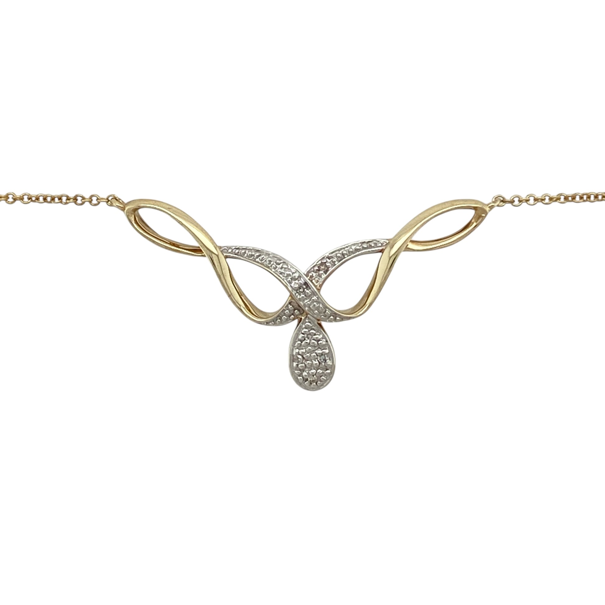 Bring graceful movement and subtle sparkle to your jewellery collection with this pre-owned 9ct yellow and white gold diamond set swirl necklace, a refined design with timeless elegance.

Design: The necklace features a flowing swirl motif accented with diamonds, creating a soft and elegant focal point with gentle sparkle.
Material: Made from a combination of 9-carat yellow and white gold, the contrasting tones add depth and highlight the fluid design.