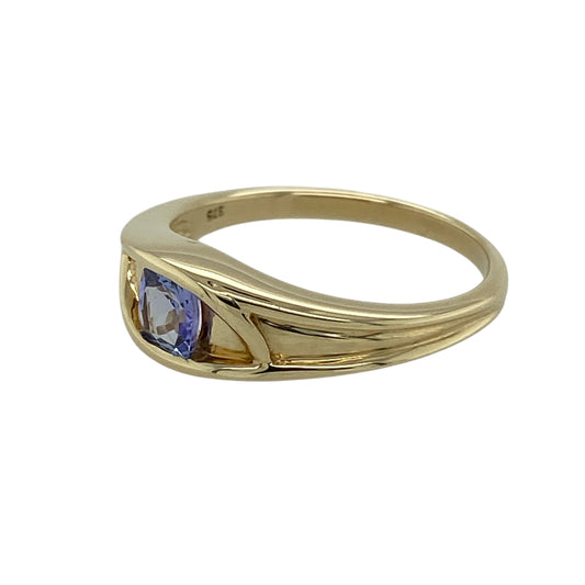Bring elegant colour and refined style to your jewellery collection with this pre-owned 9ct yellow gold tanzanite set band ring, a timeless design with a touch of distinctive charm.

Design: The ring features a square tanzanite stone measuring 4mm by 4mm, forming a striking focal point within the clean and elegant band design.
Material: Made from polished 9-carat yellow gold, the warm tone beautifully contrasts with the cool violet-blue hue of the tanzanite.
