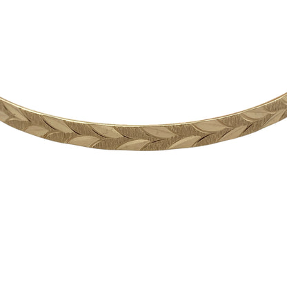 Bring classic style and everyday elegance to your jewellery collection with this pre-owned 9ct yellow solid gold patterned bangle, a timeless piece with refined detailing.

Design: The bangle features a patterned finish across a slim 4mm wide band, adding subtle texture and visual interest while maintaining a clean, elegant look.
Material: Made from solid polished 9-carat yellow gold, the warm tone enhances the patterned detailing and classic appeal of the piece.