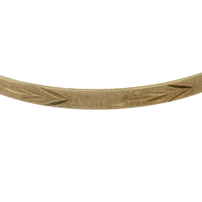 Bring classic style and everyday elegance to your jewellery collection with this pre-owned 9ct yellow solid gold patterned bangle, a timeless piece with refined detailing.

Design: The bangle features a patterned finish across a slim 4mm wide band, adding subtle texture and visual interest while maintaining a clean, elegant look.
Material: Made from solid polished 9-carat yellow gold, the warm tone enhances the patterned detailing and classic appeal of the piece.