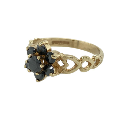 Bring classic colour and romantic detailing to your jewellery collection with this pre-owned 9ct yellow gold sapphire set flower cluster ring, a beautifully styled piece with timeless appeal.

Design: The ring features a floral-inspired cluster with a central sapphire measuring approximately 4mm in diameter, forming an elegant focal point. The decorative front measures 10mm high, giving the ring a refined yet noticeable presence.