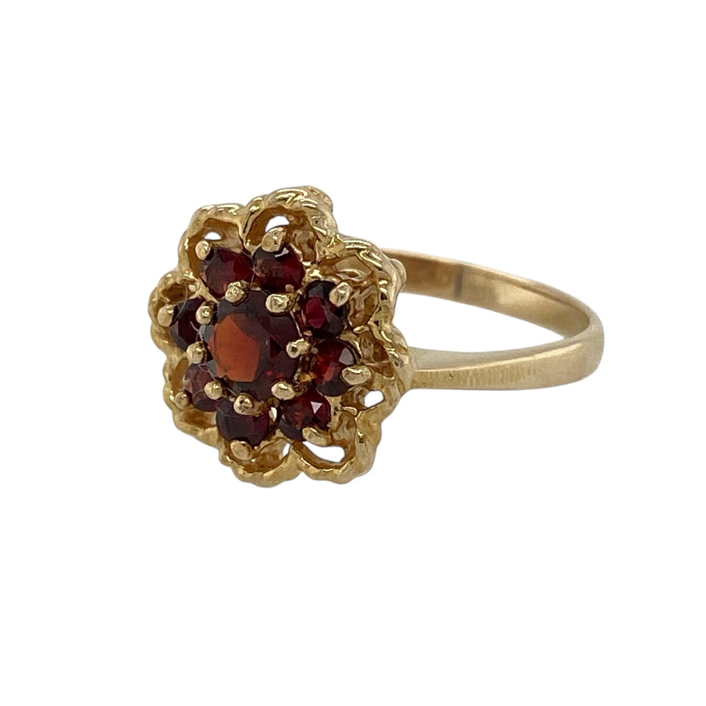Bring rich colour and classic elegance to your jewellery collection with this pre-owned 9ct yellow gold garnet set flower cluster ring, a beautifully styled piece with timeless appeal.

Design: The ring features a floral-inspired cluster centred with a round garnet measuring approximately 4mm in diameter, creating a striking focal point. The decorative front measures 12mm high, giving the ring a bold yet elegant presence.
