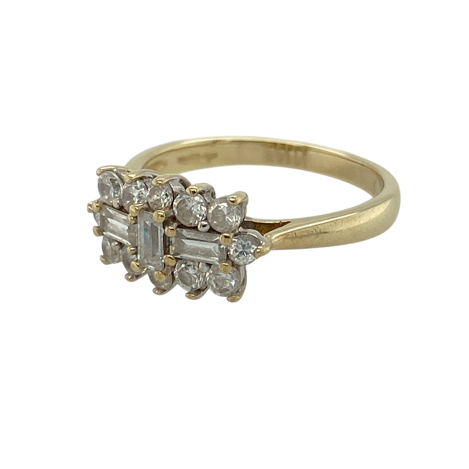 Bring classic sparkle and refined detail to your jewellery collection with this pre-owned 9ct yellow gold cubic zirconia set cluster ring, a beautifully styled piece with elegant brilliance.

Design: The ring features a cluster arrangement combining brilliant and baguette-cut cubic zirconia stones, creating a striking and dimensional focal point. The decorative front measures 8mm high, offering a balanced and eye-catching presence.