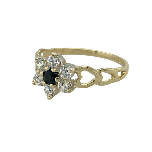 Bring delicate colour and classic sparkle to your jewellery collection with this pre-owned 9ct yellow gold sapphire & cubic zirconia set flower cluster ring, a timeless design with graceful charm.

Design: The ring features a floral-inspired cluster with a central sapphire measuring 3mm in diameter, surrounded by cubic zirconia stones that enhance the sparkle and define the flower shape.