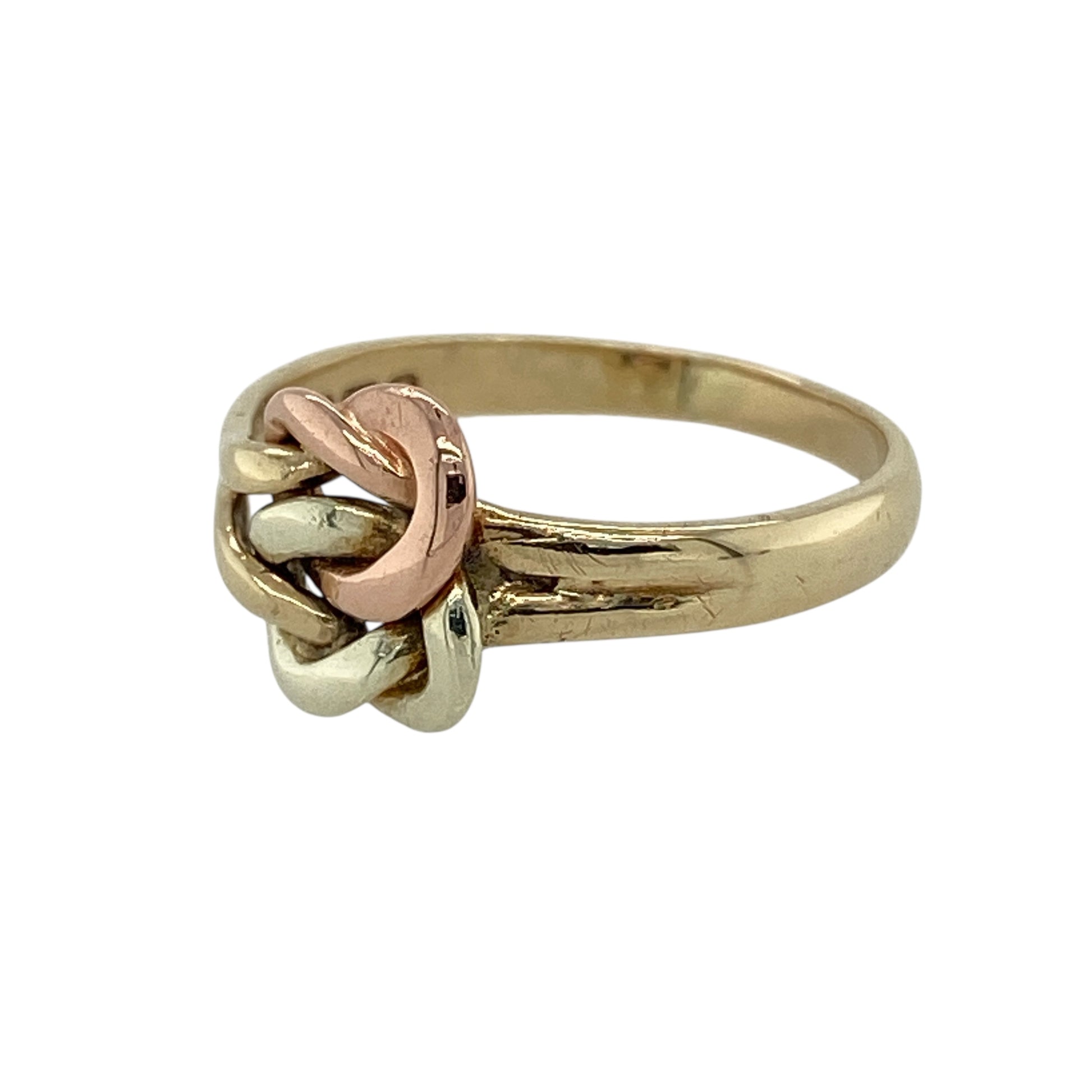 Bring timeless symbolism and elegant contrast to your jewellery collection with this pre-owned 9ct yellow, rose and white gold knot ring, a beautifully balanced design rich in meaning.

Design: The ring features an intertwined knot motif across the front, measuring 9mm high, creating a distinctive and eye-catching focal point.
Material: Made from a combination of 9-carat yellow, rose, and white gold, the contrasting tones add depth and highlight the intricate knot detailing.