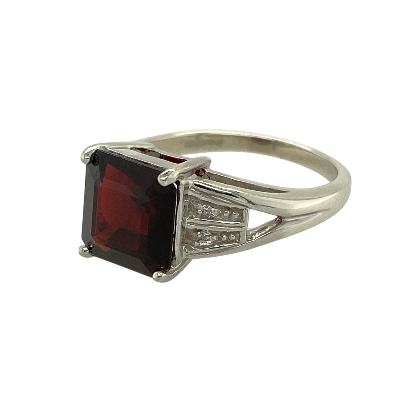 Bring bold contrast and refined sparkle to your jewellery collection with this pre-owned 9ct white gold diamond & garnet set ring, a striking design with timeless appeal.

Design: The ring features a square garnet-coloured stone measuring 9mm by 9mm, creating a strong and eye-catching focal point, accented with diamonds for added brilliance.
Material: Made from polished 9-carat white gold, the cool-toned finish beautifully complements the deep red hue of the garnet and the sparkle of the diamonds.