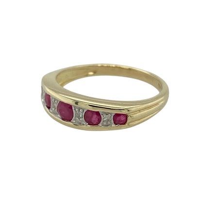 Bring rich colour and refined sparkle to your jewellery collection with this pre-owned 9ct yellow gold diamond & ruby set band ring, a beautifully detailed design with classic elegance.

Design: The ring features a central ruby measuring 3mm in diameter, with additional rubies graduating in size along the band. Small diamonds are set between the rubies, adding subtle sparkle and enhancing the flowing, balanced layout.