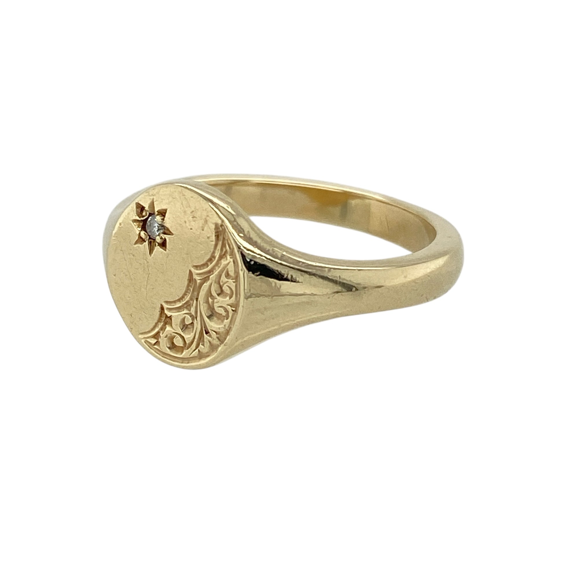 Bring classic character and refined sparkle to your jewellery collection with this pre-owned 9ct yellow gold diamond set patterned oval signet ring, a timeless design with elegant detailing.

Design: The ring features an oval signet face with decorative patterned detailing, with the front measuring 10mm high to create a balanced and confident presence. A diamond accent adds subtle sparkle to the traditional signet style.