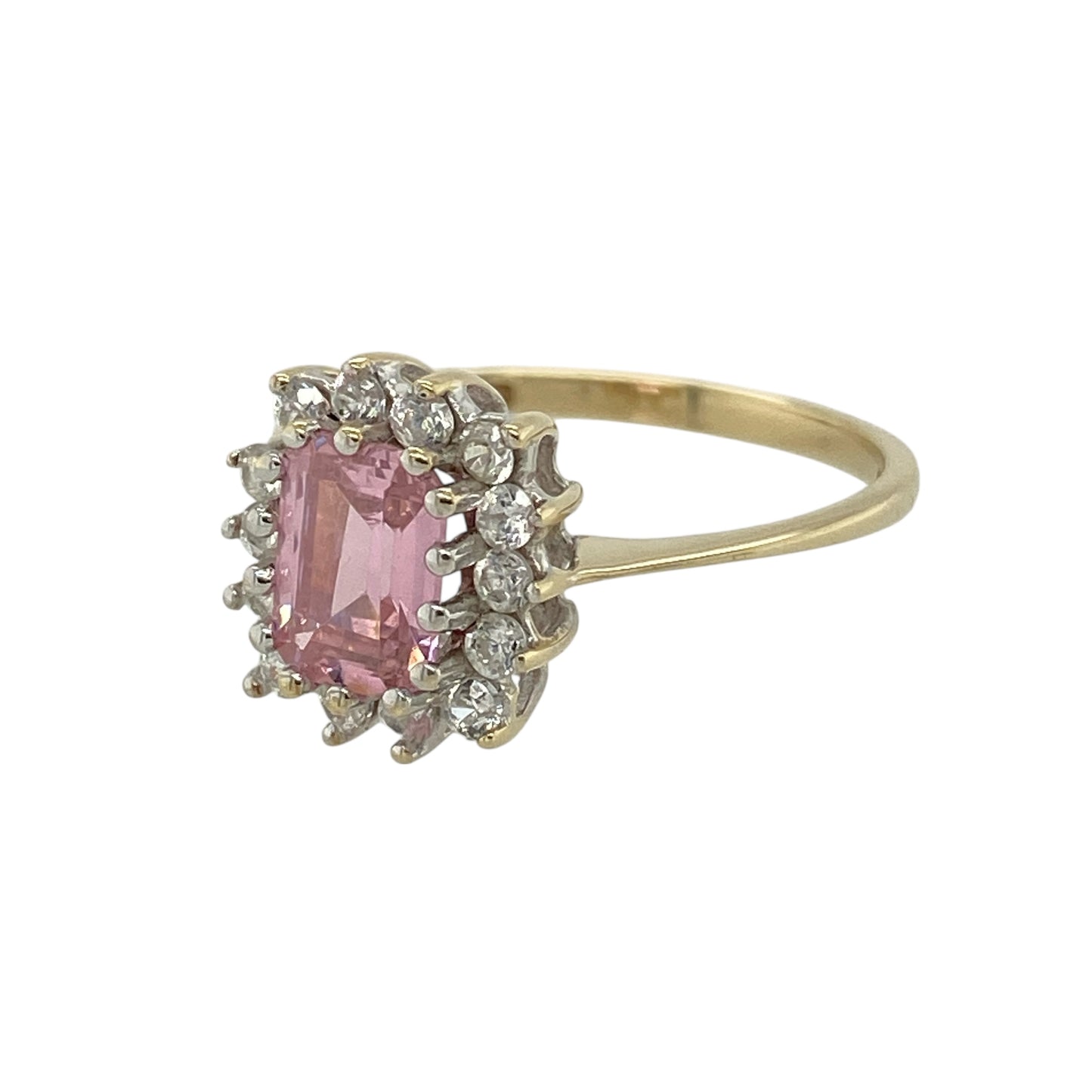 Bring soft colour and refined sparkle to your jewellery collection with this pre-owned 9ct yellow gold pink stone & cubic zirconia set cluster ring, a graceful design with elegant appeal.

Design: The ring features a rectangular pink stone measuring 7mm by 5mm, forming a delicate focal point, surrounded by cubic zirconia stones in a classic cluster arrangement.