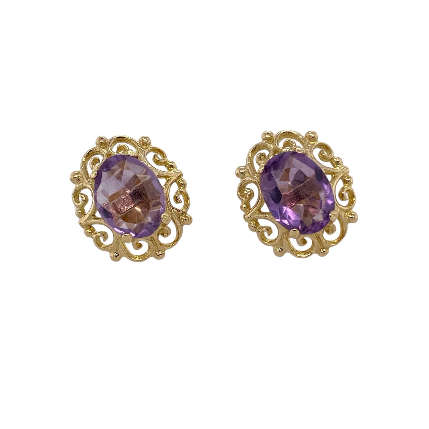 Bring rich colour and ornate detail to your jewellery collection with these pre-owned 9ct yellow gold amethyst set fancy scroll patterned stud earrings, a striking design with vintage-inspired charm.

Design: Each stud features an oval amethyst stone measuring 9mm by 7mm, framed by an intricate scroll-patterned setting that creates an elegant and decorative focal point.
Material: Made from polished 9-carat yellow gold, the warm tone beautifully complements the deep purple hue of the amethysts.