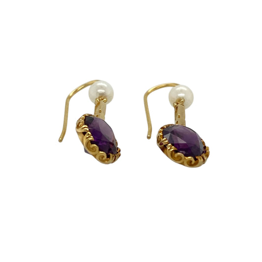 Bring elegant colour contrast and timeless charm to your jewellery collection with these pre-owned 9ct yellow gold amethyst & pearl set drop earrings, a graceful design with classic appeal.

Design: Each earring features an oval amethyst-coloured stone measuring 9mm by 7mm, suspended above a delicate synthetic pearl measuring approximately 4mm in diameter, creating a beautifully balanced drop style.