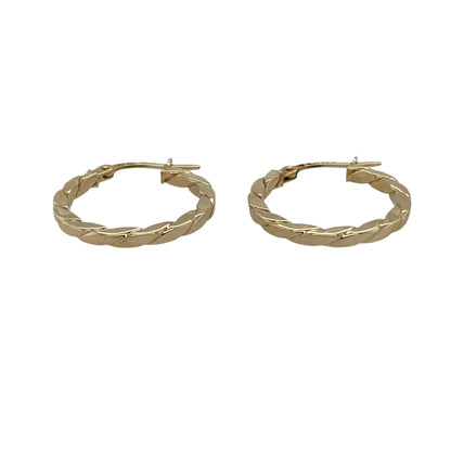 Bring classic texture and everyday elegance to your jewellery collection with these pre-owned 9ct yellow gold flat twisted hoop creole earrings, a timeless design with refined detail.

Design: Each earring features a flat twisted hoop creole style, offering a subtle twist pattern that adds depth and visual interest while maintaining a clean silhouette.
Material: Made from polished 9-carat yellow gold, the warm golden tone beautifully highlights the twisted detailing.