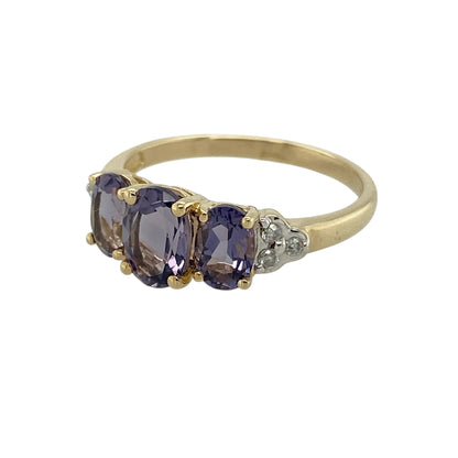 Bring elegant colour and refined sparkle to your jewellery collection with this pre-owned 9ct yellow gold diamond and tanzanite set trilogy ring, a beautifully balanced design with timeless appeal.

Design: The ring showcases a striking oval tanzanite at the centre, flanked by two smaller oval tanzanite stones, with diamond accents on either side to enhance the overall brilliance and symmetry of the trilogy layout.