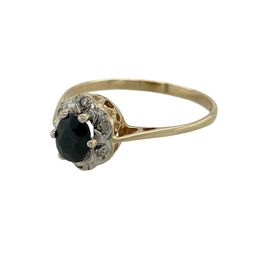Bring timeless elegance and classic gemstone beauty to your jewellery collection with this pre-owned 9ct yellow gold diamond and sapphire set cluster ring, a refined design with enduring appeal.

Design: The ring features a deep blue oval sapphire at the centre, framed by a halo of sparkling diamonds in a traditional cluster style that enhances brilliance and visual impact.