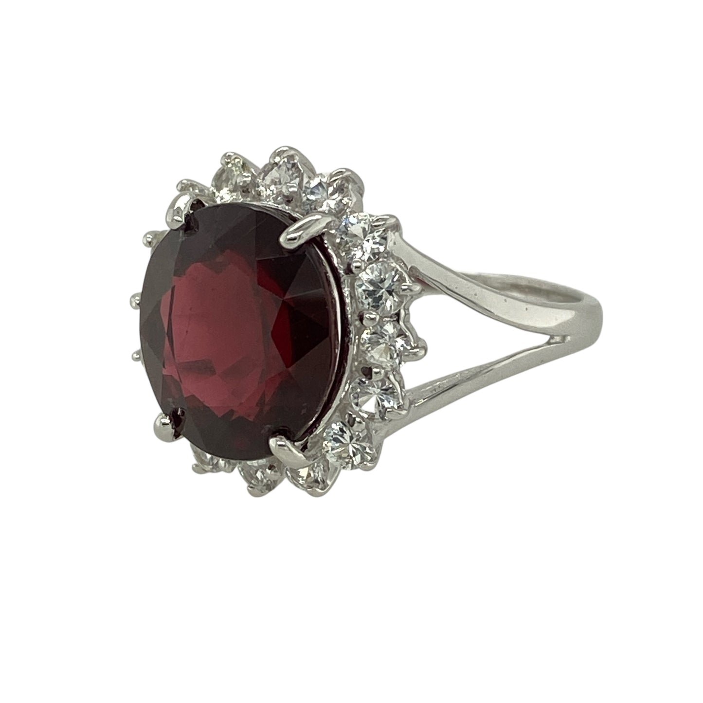 Bring rich colour and elegant sparkle to your jewellery collection with this pre-owned 9ct white gold raspberry rhodolite and white sapphire set cluster ring, a striking design with refined presence.

Design: This ring features a vibrant oval raspberry rhodolite garnet at the centre, framed by a halo of white sapphires that enhance its depth of colour and create a beautifully balanced cluster design.
Material: Made from 9-carat white gold
