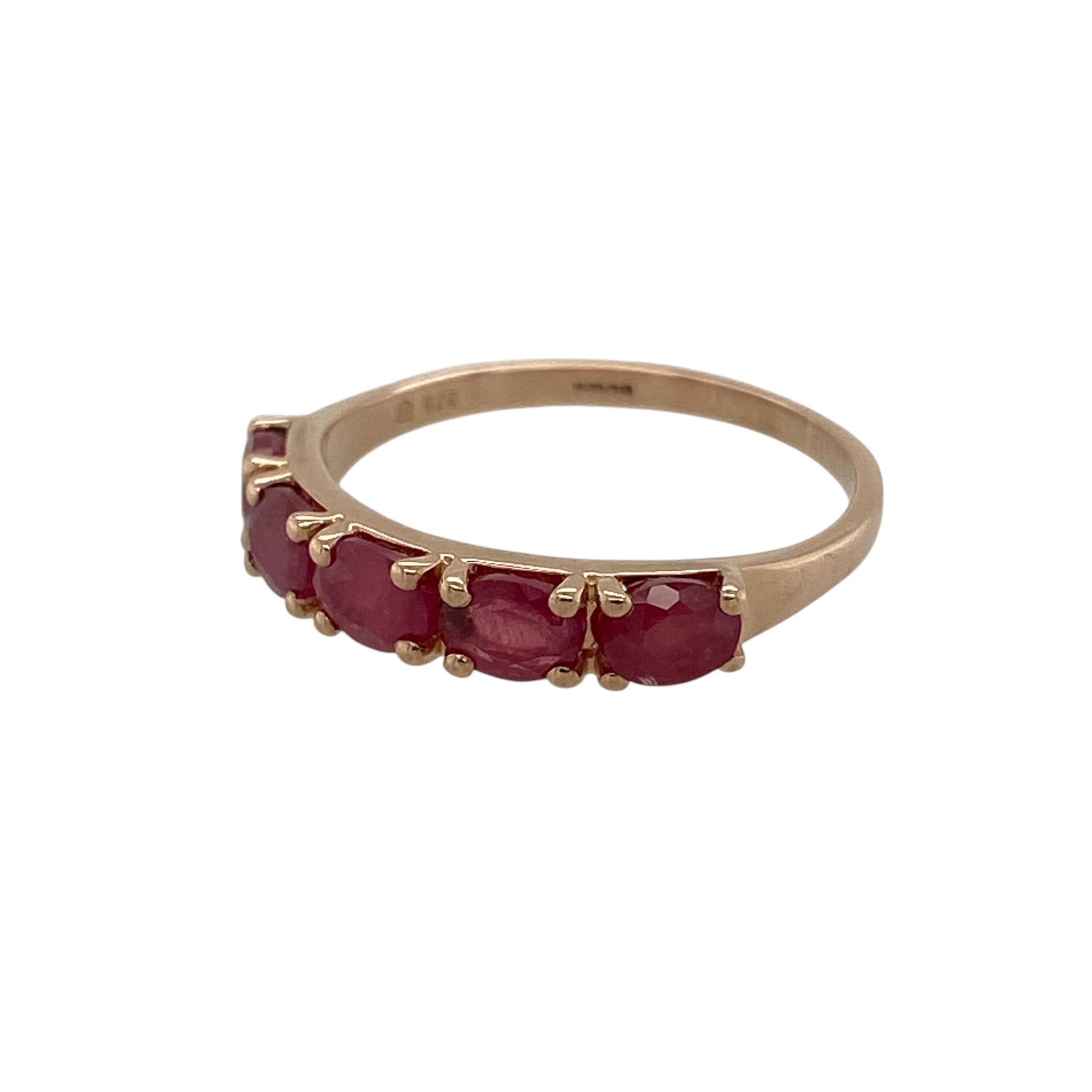 Bring warm colour and delicate elegance to your jewellery collection with this pre-owned 9ct rose gold ruby set band ring, a refined piece with timeless charm.

Design: This ring features five oval rubies arranged across the band, creating a graceful line of rich red colour that contrasts beautifully with the soft blush tone of the rose gold.
Material: Made from 9-carat rose gold, the warm pink hue enhances the vibrancy of the rubies and adds a romantic, contemporary feel.