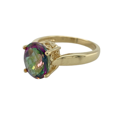 Bring captivating colour and elegant simplicity to your jewellery collection with this pre-owned 9ct yellow gold mystic topaz set solitaire ring, a striking piece with contemporary charm.

Design: This ring features a single oval mystic topaz at the centre, showcasing its vibrant, colour-shifting hues in a clean and elegant solitaire style.
Material: Made from 9-carat yellow gold, the warm polished finish beautifully complements the iridescent tones of the mystic topaz.