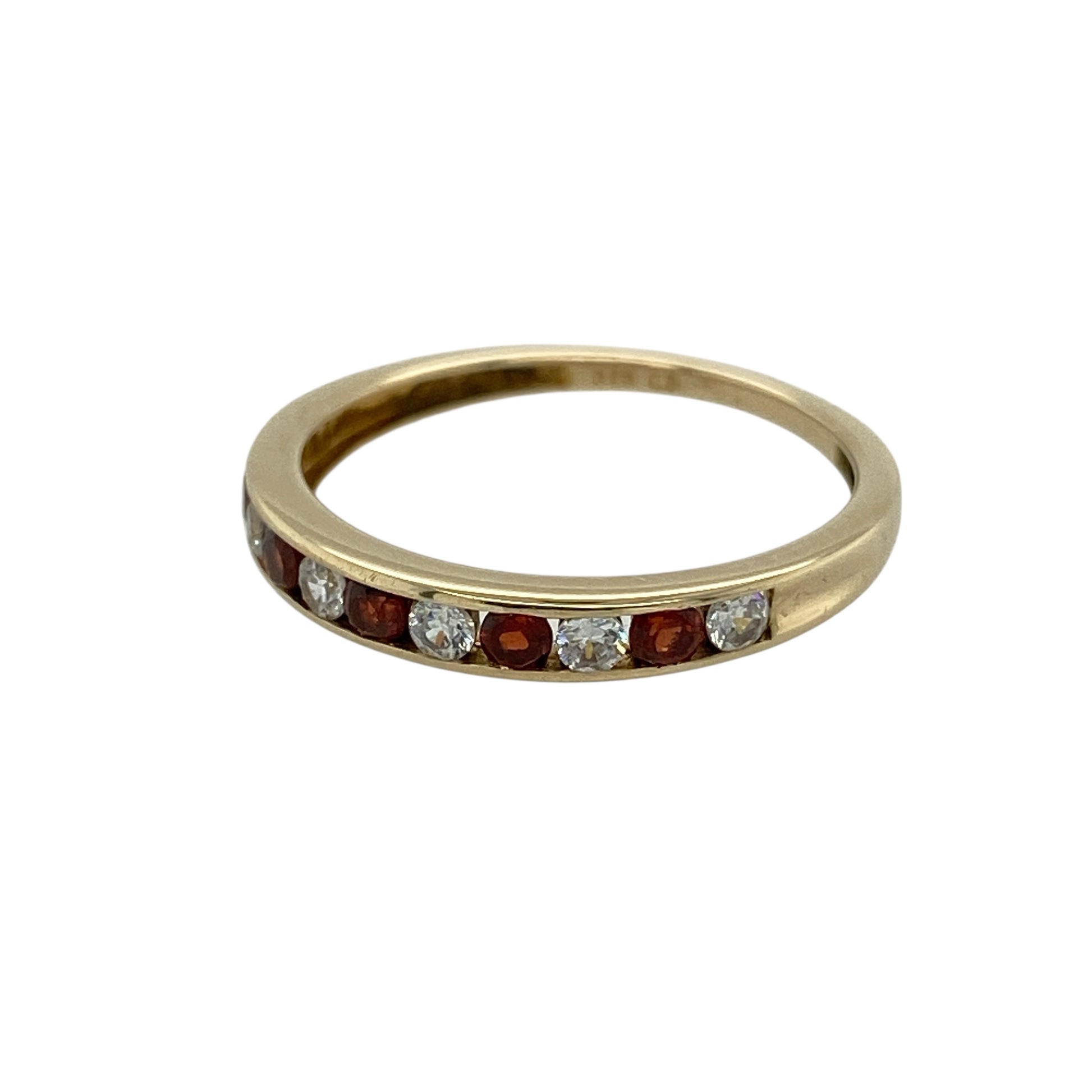 Bring rich colour and subtle sparkle to your jewellery collection with this pre-owned 9ct gold garnet and cubic zirconia set band ring, a refined piece with classic charm.

Design: This ring features a slim band adorned with deep red garnet stones, complemented by cubic zirconia accents that add gentle brilliance and contrast.
Material: Made from 9-carat gold, the warm polished finish enhances the rich tones of the garnets and the sparkle of the cubic zirconias.