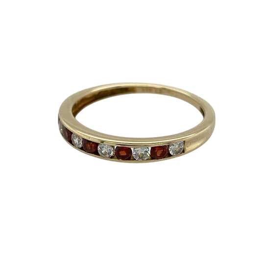 Bring rich colour and subtle sparkle to your jewellery collection with this pre-owned 9ct gold garnet and cubic zirconia set band ring, a refined piece with classic charm.

Design: This ring features a slim band adorned with deep red garnet stones, complemented by cubic zirconia accents that add gentle brilliance and contrast.
Material: Made from 9-carat gold, the warm polished finish enhances the rich tones of the garnets and the sparkle of the cubic zirconias.
