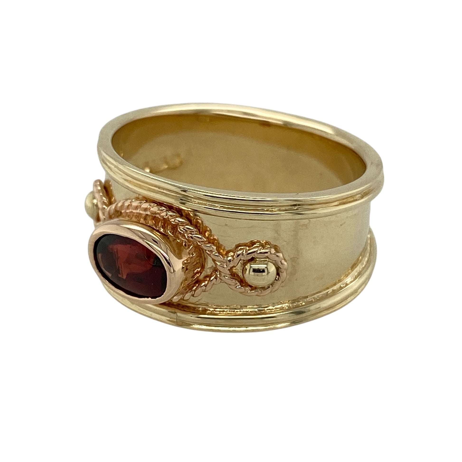 Bring rich colour and bold Welsh-inspired design to your jewellery collection with this pre-owned 9ct yellow and rose gold garnet set wide band Clogau ring, a striking piece with timeless symbolism and presence.

Design: This ring features a wide band design highlighted by a deep red oval garnet at the centre, combining classic elegance with strong, statement styling.