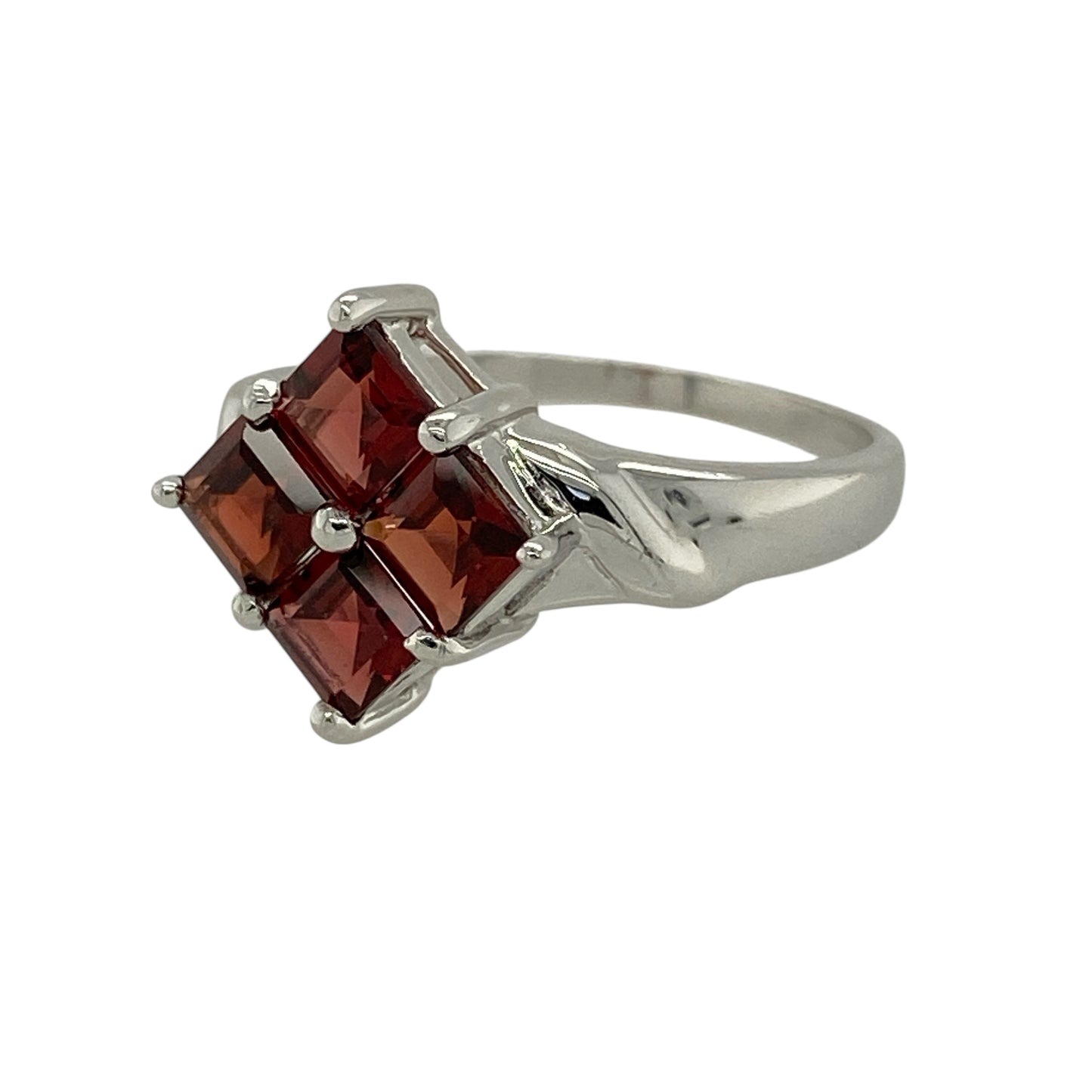 Bring deep colour and contemporary elegance to your jewellery collection with this pre-owned 9ct white gold Mozambique garnet set ring.

Design: The ring is composed of four square-cut Mozambique garnet stones, each measuring approximately 4mm by 4mm, arranged in a diamond-shaped formation to create a striking and modern focal point.
Material: Made from 9-carat white gold, the polished finish enhances the rich red tones of the garnets and adds a bright, refined contrast.