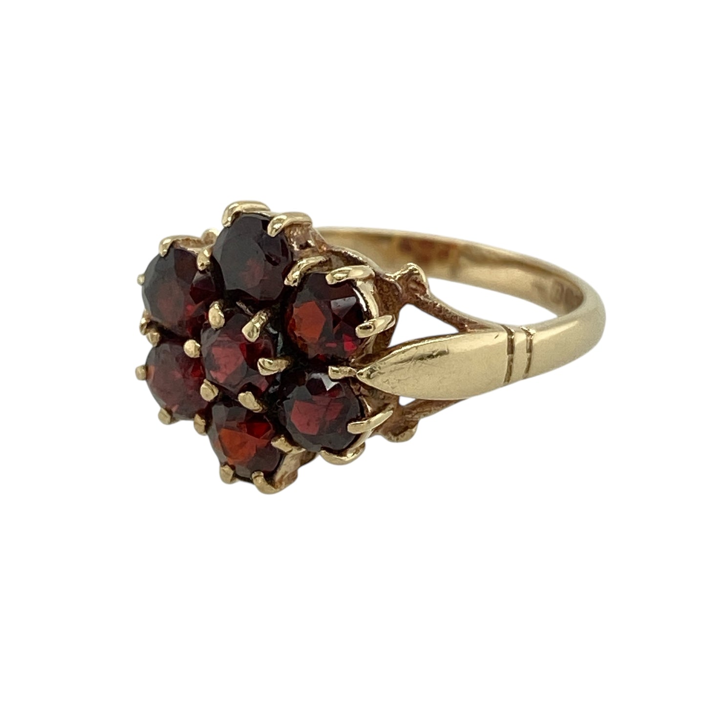 Bring rich colour and timeless floral elegance to your jewellery collection with this pre-owned 9ct yellow gold garnet set flower cluster ring.

Design: The ring features a classic flower cluster design formed from deep red garnet stones, each measuring approximately 4mm in diameter, creating a bold and eye-catching floral arrangement.
Material: Made from 9-carat yellow gold, the warm polished finish beautifully complements the rich tones of the garnets.
