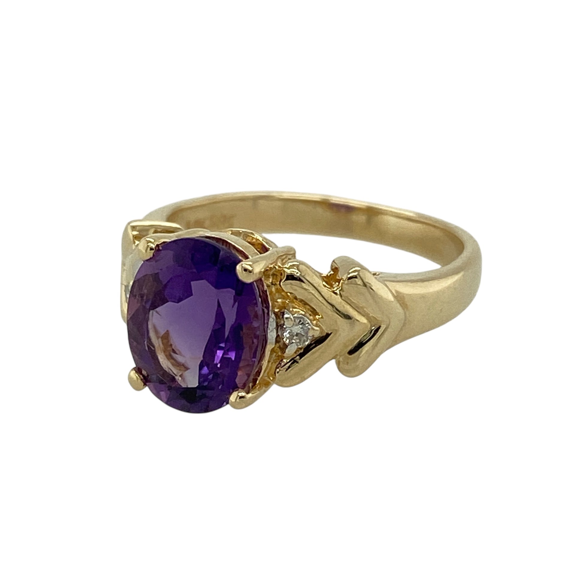 Bring rich colour and elegant sparkle to your jewellery collection with this pre-owned 14ct yellow gold diamond and amethyst set ring.

Design: The ring features an oval amethyst at the centre, measuring approximately 9mm by 7mm, complemented by sparkling diamond accents that enhance its deep purple tones.
Material: Made from 14-carat yellow gold, the warm polished finish beautifully highlights the colour of the amethyst and the brilliance of the diamonds.