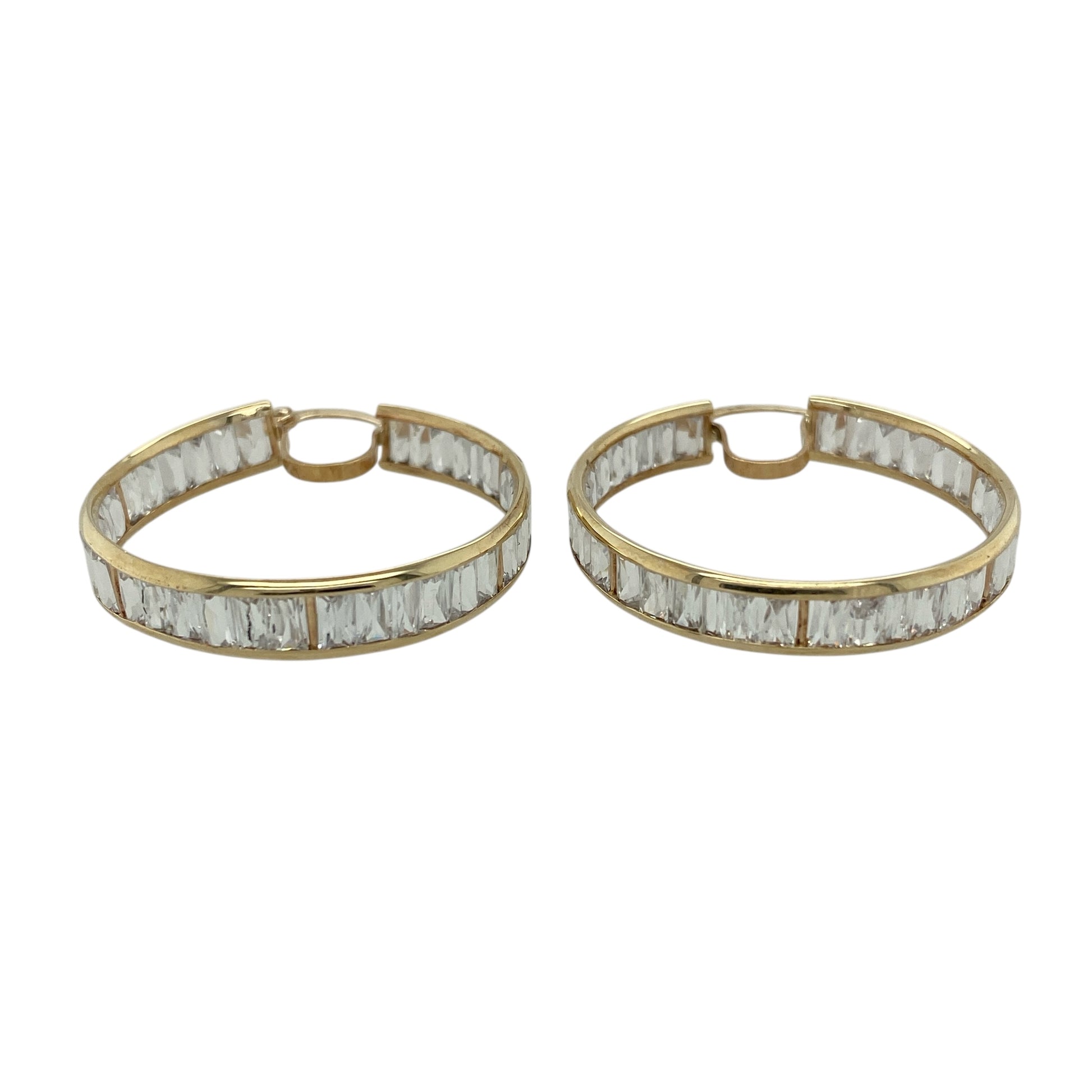 Bring bold sparkle and classic elegance to your jewellery collection with these pre-owned 9ct yellow gold and cubic zirconia set hoop creole earrings.

Design: The earrings feature a timeless hoop creole shape, set with shimmering cubic zirconia stones that add eye-catching brilliance throughout the design.
Material: Made from 9-carat yellow gold, the warm polished finish beautifully complements the bright sparkle of the cubic zirconia. 