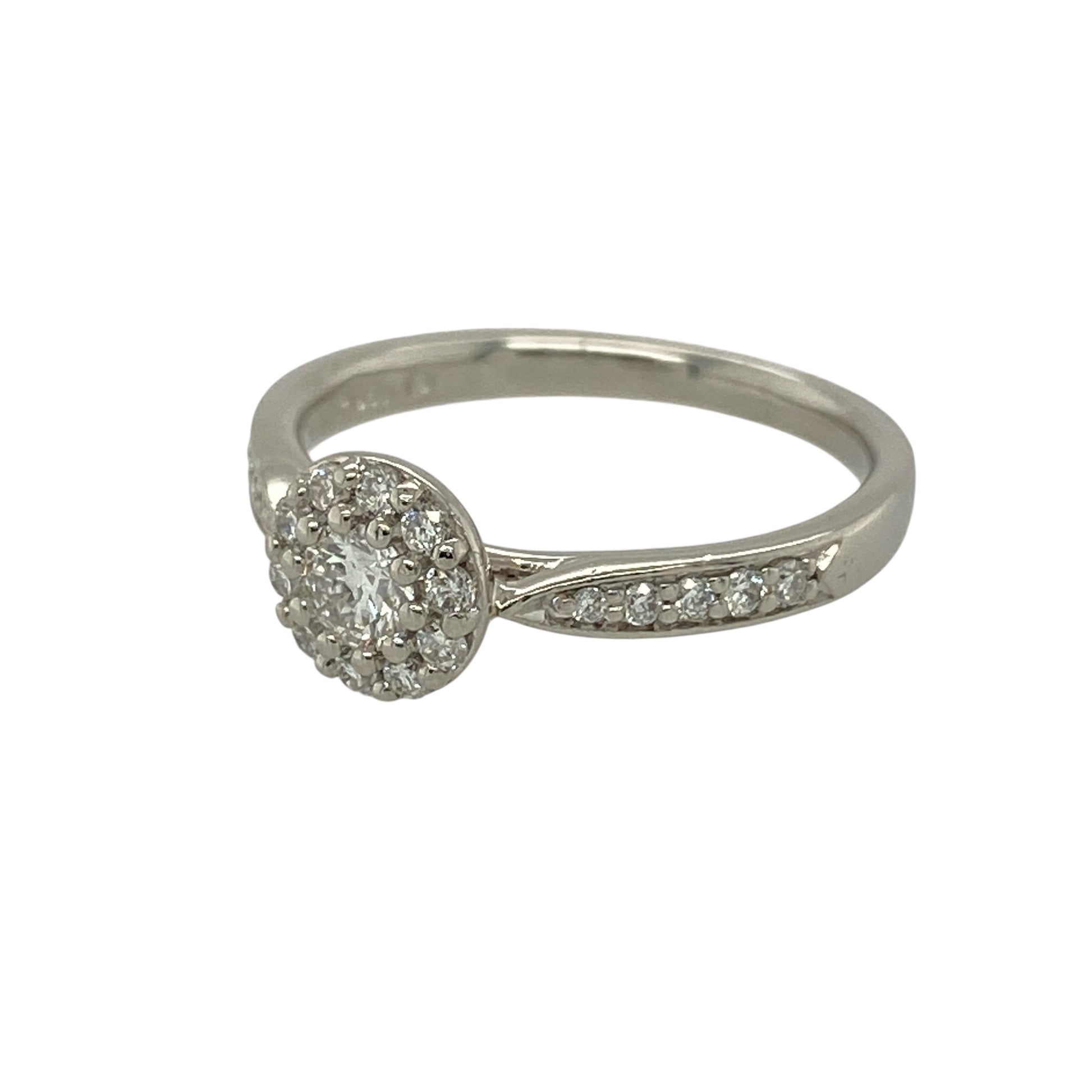 Bring timeless brilliance and refined elegance to your jewellery collection with this pre-owned platinum and diamond set halo ring.

Design: The ring features a brilliant-cut diamond at the centre, surrounded by a halo of smaller diamonds, with additional diamonds set along the shoulders for enhanced sparkle and presence.
Material: Made from platinum, the naturally bright and durable finish beautifully enhances the fire and brilliance of the diamonds.