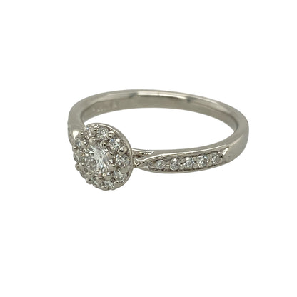 Bring timeless brilliance and refined elegance to your jewellery collection with this pre-owned platinum and diamond set halo ring.

Design: The ring features a brilliant-cut diamond at the centre, surrounded by a halo of smaller diamonds, with additional diamonds set along the shoulders for enhanced sparkle and presence.
Material: Made from platinum, the naturally bright and durable finish beautifully enhances the fire and brilliance of the diamonds.