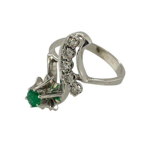 Bring fresh colour and elegant movement to your jewellery collection with this pre-owned 18ct white gold diamond and emerald set twist dress ring, combining classic gemstones with a refined flowing design—perfect for special occasions or sophisticated everyday wear.

Design: The ring features a vivid emerald stone at the centre measuring approximately 3mm in diameter, complemented by diamond accents within a graceful twist-style setting that adds softness and visual interest.