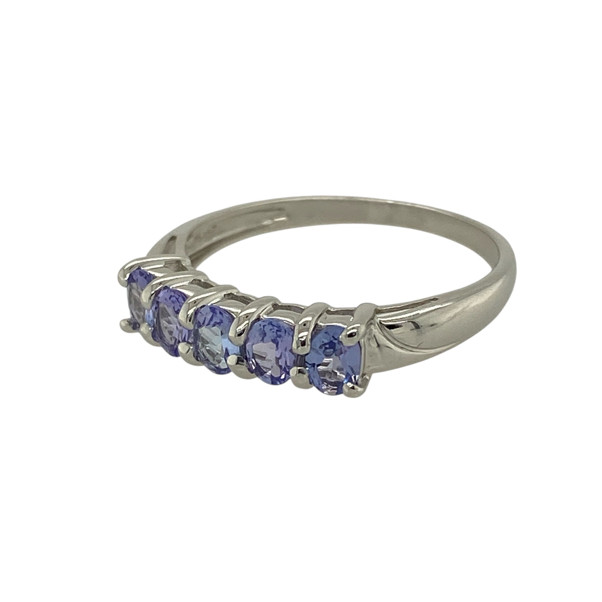 Bring rich colour and refined elegance to your jewellery collection with this pre-owned 9ct white gold tanzanite set five stone band ring, offering a timeless design with beautiful balance—perfect for everyday wear or special occasions.

Design: The ring features five oval tanzanite stones, each measuring approximately 4mm by 3mm, arranged in a classic row to create a striking and harmonious look.