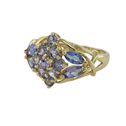 Bring rich colour and statement elegance to your jewellery collection with this pre-owned 9ct yellow gold tanzanite set cluster ring, offering a bold design with striking presence—perfect for special occasions or standout wear.

Design: The ring features a cluster arrangement of tanzanite stones, creating a vivid and eye-catching focal point. The front of the ring measures approximately 15mm in height, giving it a strong and elegant profile on the hand.