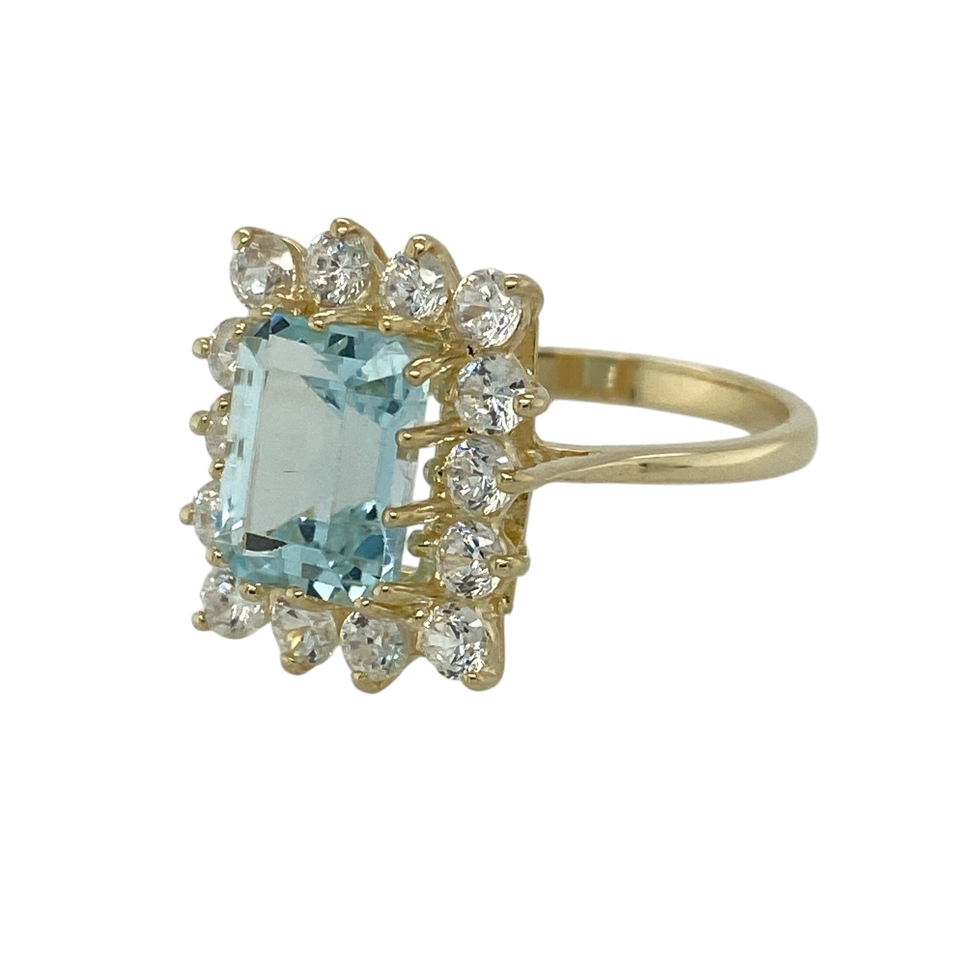 Bring fresh colour and elegant sparkle to your jewellery collection with this pre-owned 9ct gold aquamarine and cubic zirconia set cluster ring, offering a refined design with a striking centre stone—perfect for special occasions or standout everyday wear.

Design: The ring features a rectangular aquamarine stone at the centre measuring approximately 9mm by 6mm, surrounded by cubic zirconia in a classic cluster arrangement that enhances brilliance and presence.