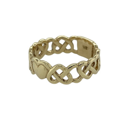 Bring symbolic charm and timeless design to your jewellery collection with this pre-owned 9ct yellow gold Celtic open heart band ring, offering meaningful detail with a bold yet elegant profile—perfect for everyday wear or as a thoughtful gift.

Design: The ring features a Celtic-inspired open heart motif integrated into the band, creating a distinctive and symbolic look. The band measures approximately 6mm in width, giving it a confident and well-balanced presence. 