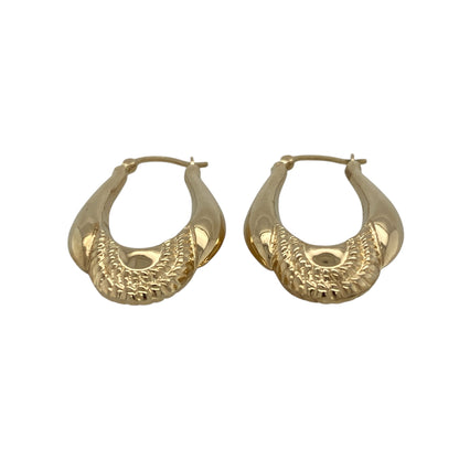 Bring classic style and refined detail to your jewellery collection with these pre-owned 9ct yellow gold patterned oval creole earrings, offering a timeless design with a more substantial feel—perfect for everyday wear or special occasions.

Design: The earrings feature an oval creole shape with a patterned finish, adding texture and visual interest while maintaining a clean and elegant look.
Material: Made from 9-carat yellow gold, the polished patterned surface enhances the warm golden tone beautifully.