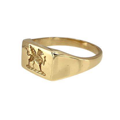 Bring heritage pride and bold style to your collection with this pre-owned 9ct yellow gold Welsh Dragon signet ring—a meaningful design with strong character.

Design: The ring features a 9mm high rectangular front engraved with the iconic Welsh Dragon, symbolising strength, courage, and national pride.
Material: Made from 9-carat yellow gold, the polished finish highlights the detailed engraving and warm golden tones.