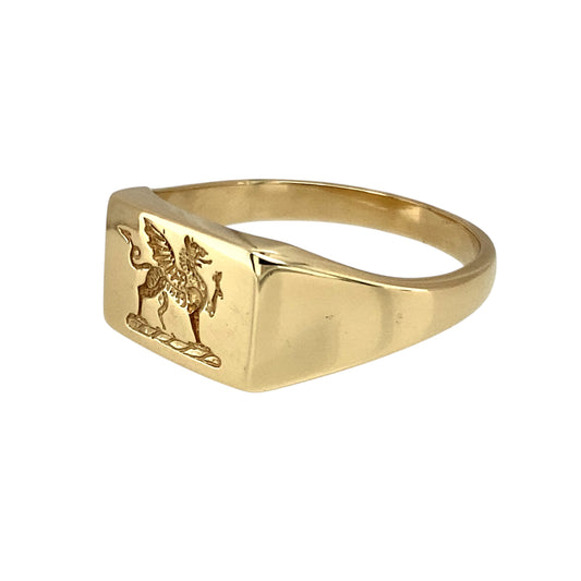 Bring heritage pride and bold style to your collection with this pre-owned 9ct yellow gold Welsh Dragon signet ring—a meaningful design with strong character.

Design: The ring features a 9mm high rectangular front engraved with the iconic Welsh Dragon, symbolising strength, courage, and national pride.
Material: Made from 9-carat yellow gold, the polished finish highlights the detailed engraving and warm golden tones.