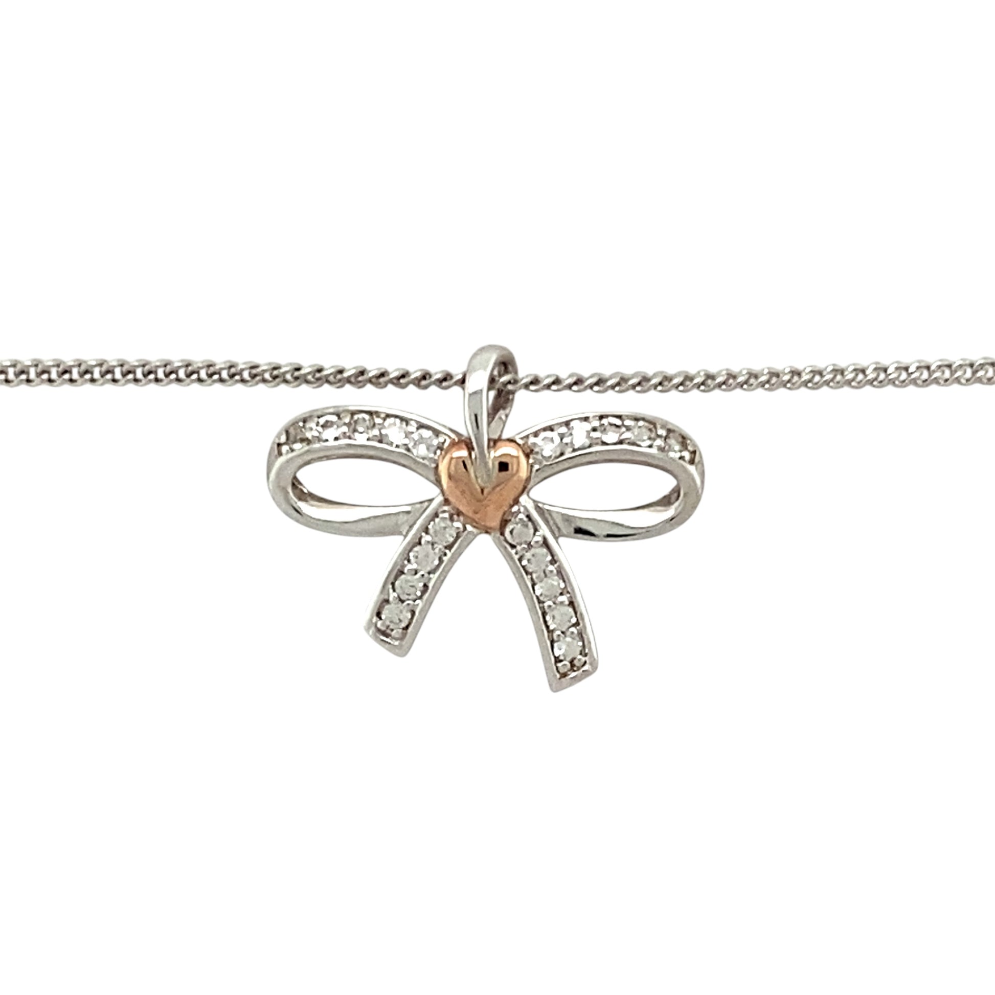Preowned 925 Silver and 9ct Rose Gold Clogau & White Topaz Set Clogau Bow Pendant on an 18”, 20" to 22" Clogau curb chain with the weight 4.20 grams. The pendant is 1.6cm long including the bail
