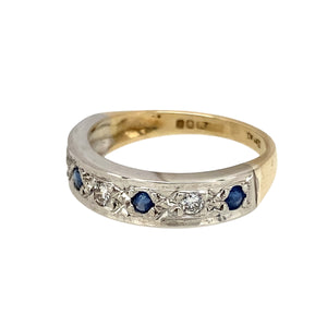 Add a touch of sophistication to your jewellery collection with this pre-owned 9ct yellow and white gold diamond & sapphire set band ring, featuring:

Design: A stylish band ring, set with deep blue sapphires and sparkling diamonds for a refined and elegant look.
Material: 9-carat yellow and white gold, creating a beautiful two-tone contrast.
Gemstones: Features 2mm diameter sapphires, complemented by dazzling diamond accents for added brilliance.
Size & Weight: Designed in size L