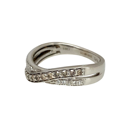 Add a unique and elegant touch to your jewellery collection with this pre-owned 14ct white gold & diamond set crossover band ring, featuring:

Design: A stylish crossover band, creating a modern and sophisticated look.
Material: Crafted in 14-carat white gold, offering a sleek and polished finish.
Gemstone Arrangement: Features a stunning combination of chocolate and white diamonds, adding depth and contrast.

