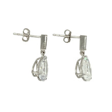 Load image into Gallery viewer, Add timeless sparkle and elegance to your jewellery collection with these pre-owned 9ct white gold teardrop drop earrings, featuring:

Design: A classic teardrop silhouette, each earring set with a sparkling cubic zirconia for a refined and graceful look.
Material: 9-carat white gold, offering a cool, polished finish that enhances the brilliance of the stones.
Gemstone Detail: Each earring features a 10mm by 7mm cubic zirconia in a faceted teardrop cut, designed to catch the light beautifully.


