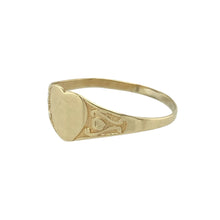 Load image into Gallery viewer, A perfect keepsake for a little one, this pre-owned 9ct yellow gold children&#39;s heart signet ring blends delicate design with timeless sentiment, featuring:

Design: A petite signet ring with a heart-shaped front, adorned with subtle patterning that adds a touch of charm and individuality.
Material: Made from 9-carat yellow gold, offering a warm, polished finish that’s both classic and gentle on young hands.

