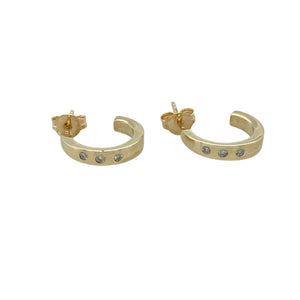 Add subtle sparkle and classic style to your collection with these pre-owned 9ct yellow gold diamond set half hoop earrings—elegant, versatile, and perfect for everyday sophistication.

Design: Each earring features a sleek half hoop design with three small diamonds set along the front, offering just the right amount of shimmer.
Material: Made from 9-carat yellow gold, the polished finish enhances the diamonds' brilliance and adds a warm, refined glow.
