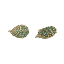 Load image into Gallery viewer, Add a pop of colour and delicate sparkle to your collection with these pre-owned 9ct yellow gold diamond and green stone set stud earrings—perfect for subtle elegance with a refined touch.

Design: Each earring features a central green stone of approximately 2mm in diameter, accented by a surrounding arrangement of small diamonds for added brilliance.
Material: Made from 9-carat yellow gold, the polished finish enhances the vibrant green stones and the light-catching sparkle of the diamonds.

