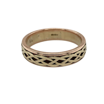 Celebrate heritage and timeless craftsmanship with this pre-owned 9ct yellow and rose gold Clogau Celtic weave band ring—a bold and meaningful design rooted in tradition.

Design: The 6mm wide band features an intricate Celtic weave pattern, blending yellow and rose gold to create a rich, interlaced design symbolising eternity and unity.
Material: Made from 9-carat yellow and rose gold, the polished finish enhances the contrast between tones and showcases the detailed weave.
