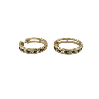 Bring luxurious sparkle and timeless colour to your collection with these pre-owned 18ct yellow gold diamond and sapphire set hoops, offering a refined blend of classic elegance and vibrant detail—perfect for adding sophistication to any look.

Design: Each hoop is adorned with alternating sapphires and diamonds, creating a stunning contrast of deep blue and brilliant sparkle that catches the light beautifully.