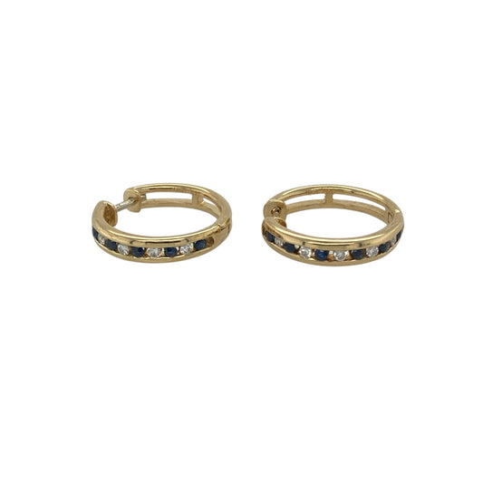 Bring luxurious sparkle and timeless colour to your collection with these pre-owned 18ct yellow gold diamond and sapphire set hoops, offering a refined blend of classic elegance and vibrant detail—perfect for adding sophistication to any look.

Design: Each hoop is adorned with alternating sapphires and diamonds, creating a stunning contrast of deep blue and brilliant sparkle that catches the light beautifully.
