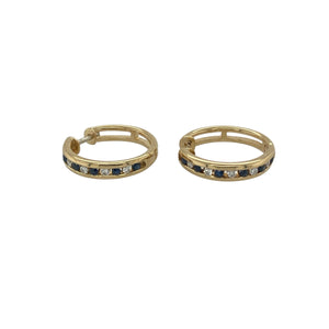 Bring luxurious sparkle and timeless colour to your collection with these pre-owned 18ct yellow gold diamond and sapphire set hoops, offering a refined blend of classic elegance and vibrant detail—perfect for adding sophistication to any look.

Design: Each hoop is adorned with alternating sapphires and diamonds, creating a stunning contrast of deep blue and brilliant sparkle that catches the light beautifully.